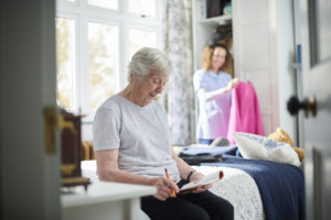 Care worker helping elderly patient with their day to day activities 
