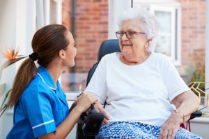 Carer taking care of elderly women in home
